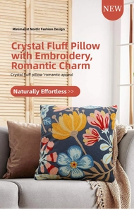 Detail of colorful floral towel embroidery on dark blue pillowcase in living room