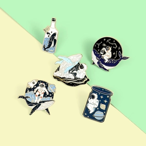 Detailed set of five enamel badges featuring whales and astronauts in starry bottles