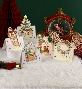 Detailed view of 3D Christmas pop-up greeting cards with golden foil lettering and festive patterns