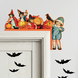 Detail of vintage Halloween wooden door corner decor featuring kids and pumpkin lanterns