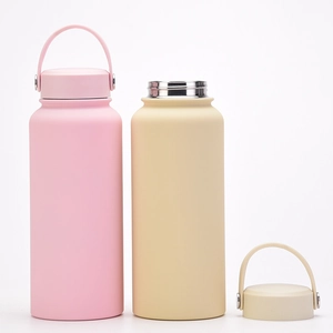 Detail of pink and beige stainless steel matte sports flasks with handle lids on white back