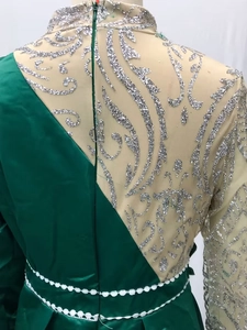 Close-up of green mermaid evening dress with silver glitter mesh and invisible back zipper