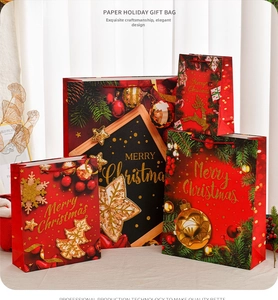 Detail of oversized Christmas gift bags with gold foil patterns and festive designs