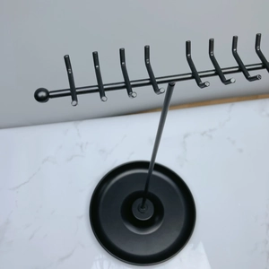 Detail of black T-shaped jewelry stand with 8 hooks for necklaces and earrings
