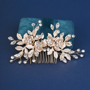 Golden bridal hair comb with crystal flowers and pearls on blue velvet box
