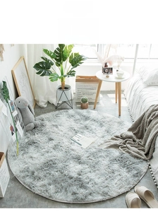 Close-up of soft gray-white plush round rug in a modern Scandinavian living room setup