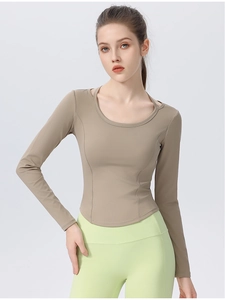 Detail of slim-fit long sleeve yoga top featuring seamless stitching and elastic fabric