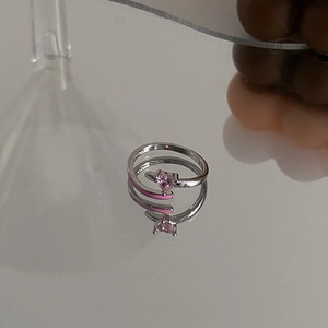 Macro detail of silver adjustable ring with pink heart stone and pink enamel finish