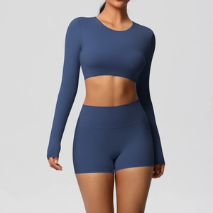 Detail of high-waist yoga shorts and long sleeve crop top in navy blue brushed fabric
