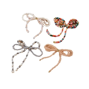 Handmade beaded bow clips in white, gold, and pearl finishes for hair and fashion