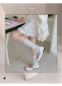 Close-up of white high elasticity knitted slouch socks with vertical ribbed texture