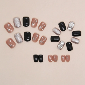 Short square press-on nails with black gloss, silver glitter, and star patterns