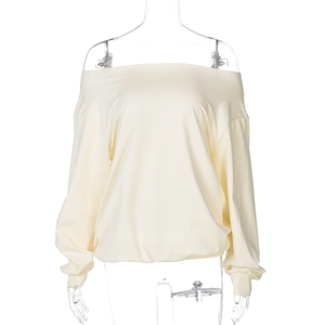 Detail view of cream yellow off-shoulder long sleeve top with ribbed cuffs on white background
