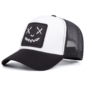 Detail of street style trucker hat showing embroidered cross-eye smiley face patch