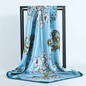 Light blue satin square scarf with white lily and yellow sunflower print pattern