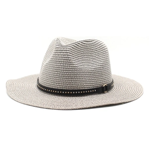 Close-up of woven straw fedora with decorative black leather band and metal studs