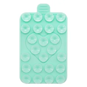 Close-up of mint green silicone suction cup phone pad with heart embossed pattern detail