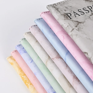 Close-up of marble texture PU leather passport covers in multiple colors with PASSPORT text