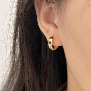 Minimalist 925 sterling silver gold hoop earrings with black enamel heart charm on ear