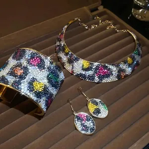 Golden luxury jewelry set with colorful leopard print necklace, bracelet and earrings
