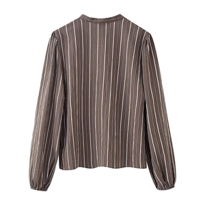 Brown long-sleeved striped shirt with vertical white stripes and pleated cuffs on white backdrop