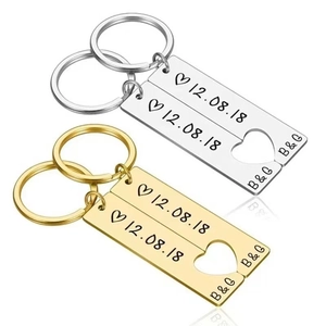 Couples' stainless steel heart puzzle keychains with custom date engraving in gold and silver
