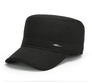 Detail view of black wool cadet cap featuring a silver oval metal emblem on the side