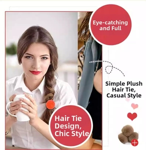 Detail of plush pompom hair ties in orange and brown with soft velvet texture
