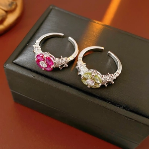 Detailed macro view of sparkling flower zircon rings with rose red and yellow green stones
