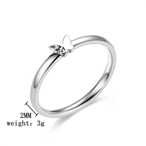 Macro side view of a minimalist 2mm silver butterfly ring in high polished titanium steel