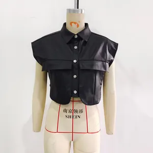 Detail of black PU leather vest featuring front pockets and silver metal buttons