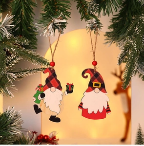 Close-up of painted wooden gnome Christmas ornaments with red and black plaid hats