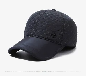 Detail view of navy blue quilted baseball cap with warm lining and diamond stitch texture