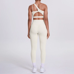 Detail of off-white one-shoulder sports bra and high-waist yoga pants from the back