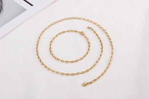 Detailed view of minimalist gold chain necklace and bracelet with lobster clasp hardware