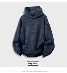 Detail of navy blue tie-dye hoodie featuring dropped shoulders and a kangaroo pocket texture