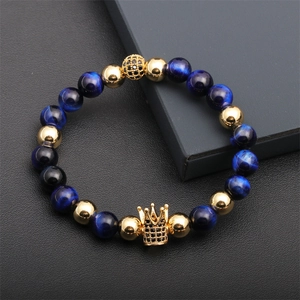 Detail of blue tiger eye beads and gold crown charm on a men's beaded bracelet