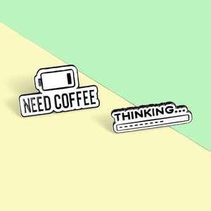Detail of alloy pins showing Need Coffee battery icon and Thinking loading bar design