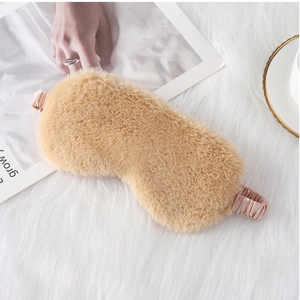 Khaki plush sleep mask with silk strap on fuzzy background for comfort and relaxation