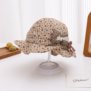 Detail of baby floral bucket hat with large polka dot bow and delicate lace trim