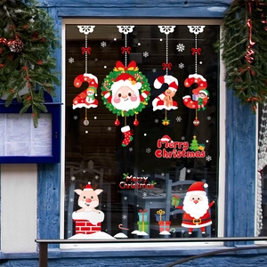 Detail of Christmas window clings with Santa, snowman, and reindeer festive motifs