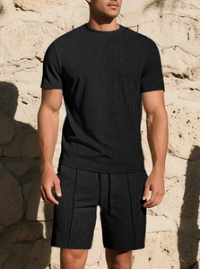 Detailed view of black men's summer set featuring textured jacquard waffle knit fabric