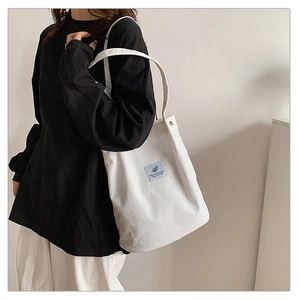 Detailed view of the white corduroy tote bag, casual daily shoulder handbag for women.