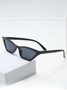 Detailed view of retro triangle cat eye sunglasses on white geometric display stand
