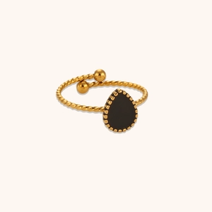 Detail showing the twisted rope texture and teardrop black onyx stone on gold ring