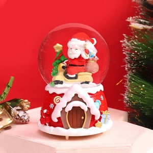Close-up of Santa on a motorcycle inside a Christmas crystal ball music box