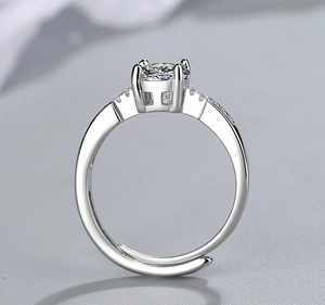 Macro detail of adjustable silver ring with four-prong set central cubic zirconia