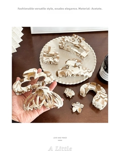 Detail of 8-piece acetate hair claw set in marble cream and coffee brown patterns