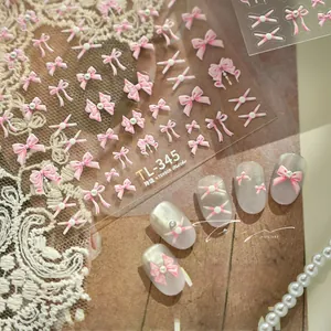 Detail of pink and white 3D bow nail art stickers TL-345 with ribbon texture on cat-eye nails