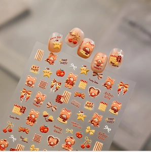 Detail view of 3D embossed nail stickers featuring caramel bear, stars and bow designs